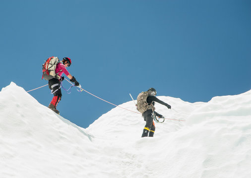 Women hiking on snowy mountain, Everest, Khumbu region, Nepal