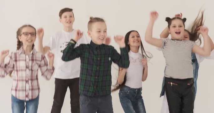 Children jumping and clapping in studio