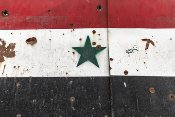 Syrian flag painting with bullet impact
