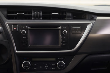 Modern car dashboard with multimedia screen. Interior detail.