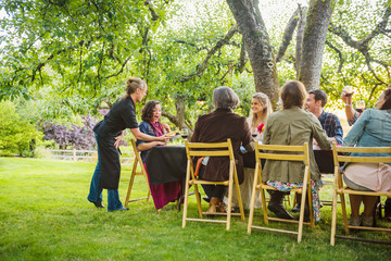 Friends enjoying wine at party outdoors