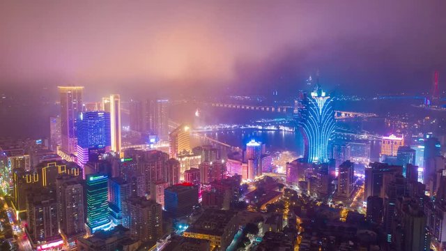 night illumination flight over macau city hotel downtown bay aerial panorama 4k timelapse china