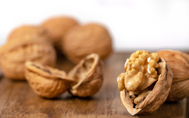 Open wallnuts closeup macro, white background on a wooden surface