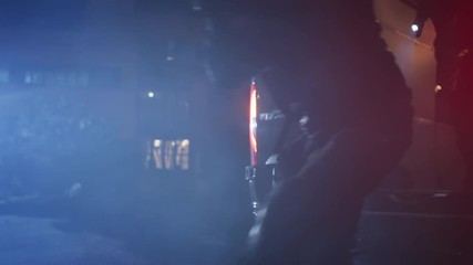 Masked Team of Armed SWAT Police Officers Exit a Black Van Parked Outside of an Office Building. Soldiers with Rifles and Flashlights Run on a Street Filled with Smoke.