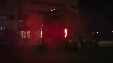 Masked Team of Armed SWAT Police Officers Exit a Black Van Parked Outside of an Office Building. Soldiers with Rifles and Flashlights Run on a Street Filled with Smoke.