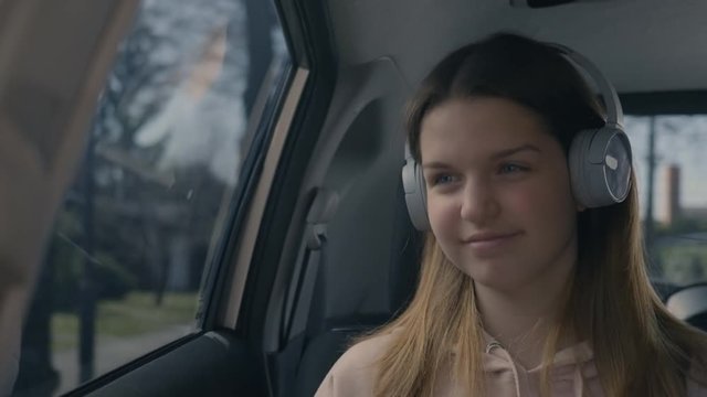 Teenager listening to music and driving around a nice neighborhood