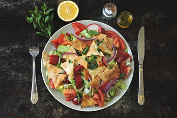 Healthy bright salad with pita bread and vegetables. Fattush Salad. Middle Eastern style.