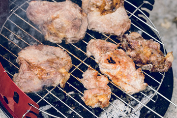 Close up on pork pig meat cooking on the barbeque outdoor grill food