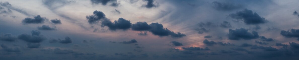Dramatic cloudscape during a dark and colorful sunset.