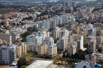 Naklejka premium Aerial view of a residential neighborhood in a city during a cloudy and sunny day. Taken in Netanya, Center District, Israel.