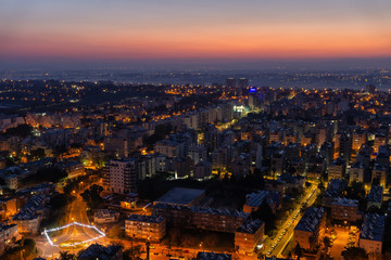 Aerial view of a residential neighborhood in a city during a vibrant and colorful sunrise. Taken in Netanya, Center District, Israel.