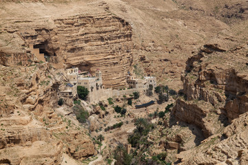 Beautiful Aerial view of Monastery of St. George in a rocky canyon during a sunny day. Located near Jerusalem in Wadi Qelt, Israel.