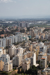 Aerial view of a residential neighborhood in a city during a cloudy and sunny day. Taken in Netanya, Center District, Israel.
