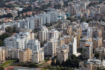 Fototapeta na wymiar Aerial view of a residential neighborhood in a city during a cloudy and sunny day. Taken in Netanya, Center District, Israel.
