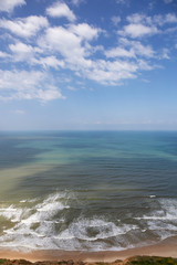 Obraz premium Beautiful aerial view of a sandy beach during a cloudy and sunny day. Taken in Netanya, Center District, Israel.