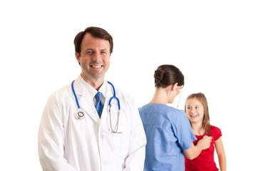 Fototapeta premium Doctor and Nurse Examining a Little Girl - Medical Healthcare