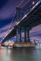 Fototapeta na wymiar Manhattan Bridge at night from east river with long exposure