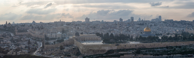 Beautiful aerial panoramic view of the Old City and Dome of the Rock during a sunny and cloudy evening. Taken in Jerusalem, Capital of Israel.