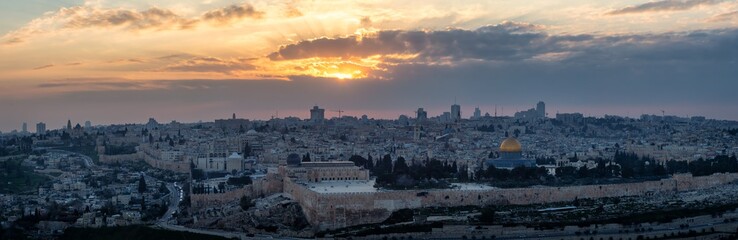 Fototapeta premium Beautiful panoramic aerial view of the Old City and Dome of the Rock during a dramatic colorful sunset. Taken in Jerusalem, Capital of Israel.