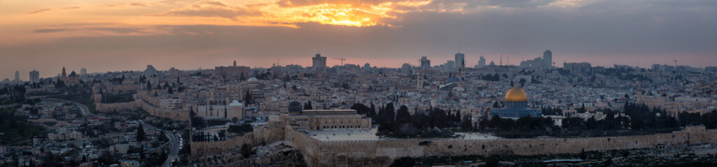 Fototapeta premium Beautiful panoramic aerial view of the Old City and Dome of the Rock during a dramatic colorful sunset. Taken in Jerusalem, Capital of Israel.