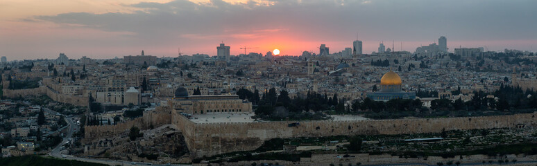 Fototapeta premium Beautiful panoramic aerial view of the Old City and Dome of the Rock during a dramatic colorful sunset. Taken in Jerusalem, Capital of Israel.