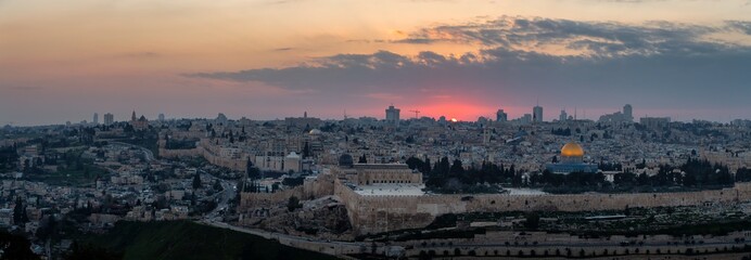 Beautiful panoramic aerial view of the Old City and Dome of the Rock during a dramatic colorful sunset. Taken in Jerusalem, Capital of Israel.