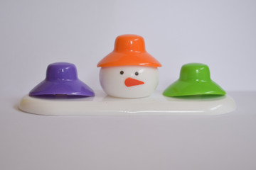 beautiful snowman with colorful caps