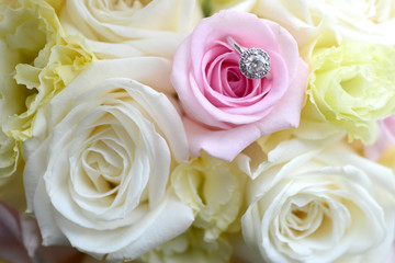 Close up of wedding rings on the bouquet