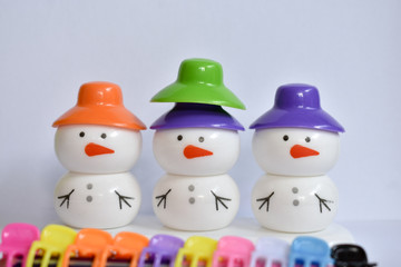 beautiful snowman with colorful caps