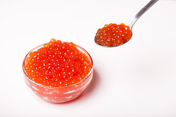 red caviar in glass bowl with spoon isolated on white background