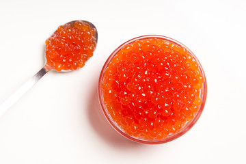 red caviar in glass bowl with spoon isolated on white background