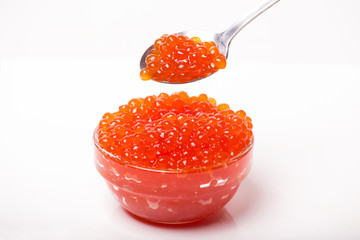 red caviar in glass bowl with spoon isolated on white background