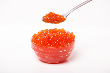 red caviar in glass bowl with spoon isolated on white background