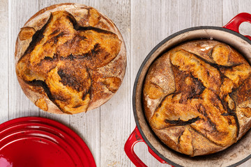 Traditional artisan bread with red baking pan, top view