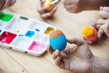 People painting colorful Easter eggs - Easter holiday celebration concept