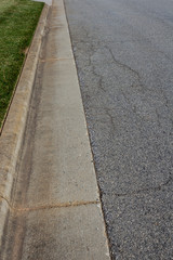 Residential street with formed curb and nicely edged grass, vertical aspect