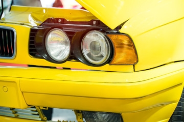red Automotive Front End headlight of the car close up