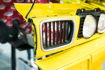 red Automotive Front End headlight of the car close up