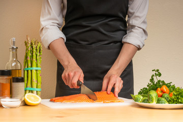 cooking chef red fish, salmon, trout. with side dish and salad. recipe book, menu, cooking tasty and wholesome food, restaurant or hotel menu