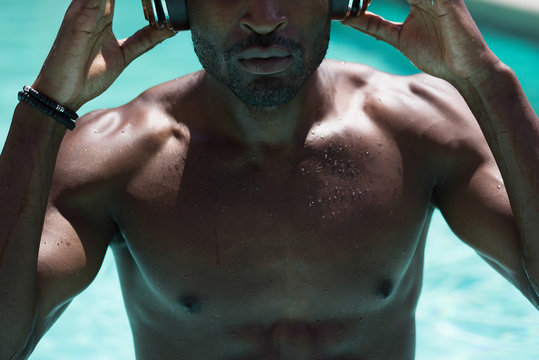 Man Wearing Headphones in the Pool