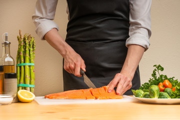 cooking chef red fish, salmon, trout. with side dish and salad. recipe book, menu, cooking tasty and wholesome food, restaurant or hotel menu