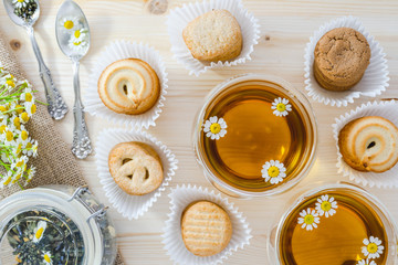 Cookies and  Chamomile Tea in a Glass Teacups on a Wooden Kitchen Table, Close Up, Top View
