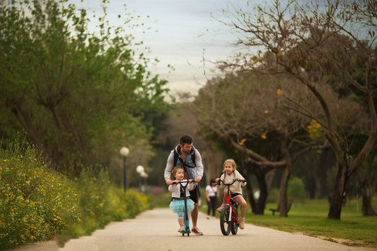 family on a morning bike ride in the Park