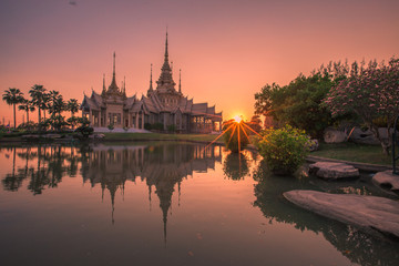 Fototapeta na wymiar Wallpaper Wat Lan Boon Mahawihan Somdet Phra Buddhacharn(Wat Non Kum)is the beauty of the church that reflects the surface of the water, popular tourists come to make merit and take a public photo