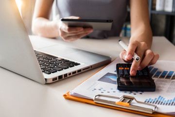 Business women are calculating daily expenses.