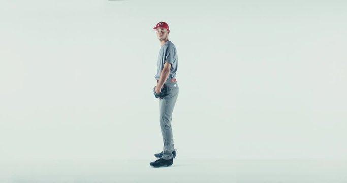 Caucasian professional baseball player pitcher posing isolated on white background. 4K UHD 60 FPS SLOW MOTION