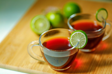 Black tea in cup with lemon