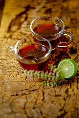 Black tea in cup with lemon