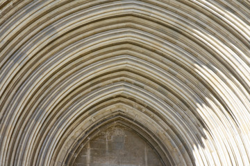 Simple archivolt at a side entrance of the Cathedral Girona (Catedral de Santa Maria de Girona), a Roman Catholic Church in Costa Brava, Catalonia, Spain.