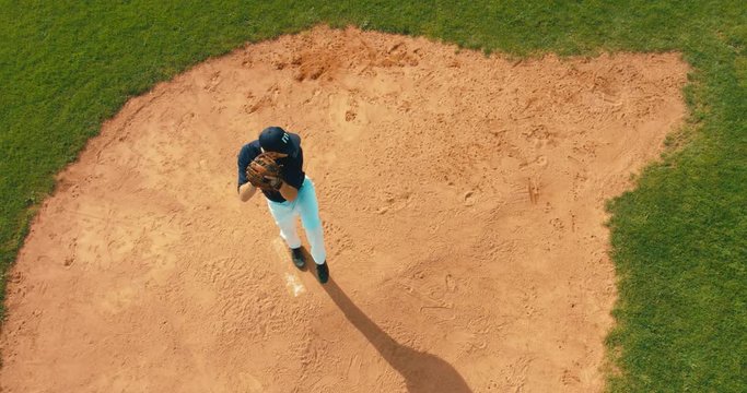 OVERHEAD CRANE Pitcher baseball player throws a ball from the pitcher's mound. 4K UHD 60 FPS SLO MO RAW